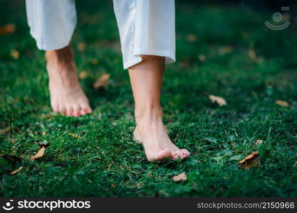 Yoga Woman Walking barefoot, focus on feet.