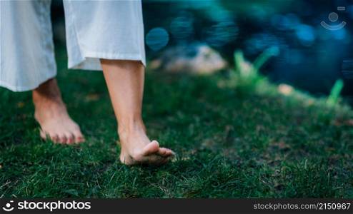 Yoga Woman Walking barefoot, focus on feet.