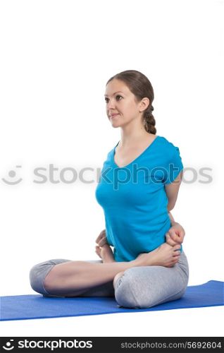 Yoga - young beautiful woman yoga instructor doing bound lotus pose (Baddha Padmasana) exercise isolated on white background