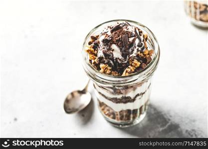 Yogurt parfait with granola, chocolate and ice cream. Sweet delicious breakfast