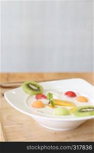 yogurt with fruit on wood background
