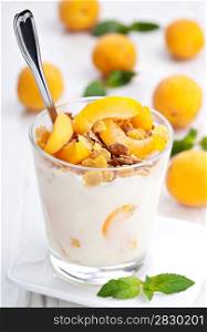 yogurt with muesli and apricot in small glass