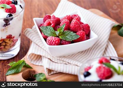 yogurt with muesli and berries. yogurt with muesli and berries on a wooden table