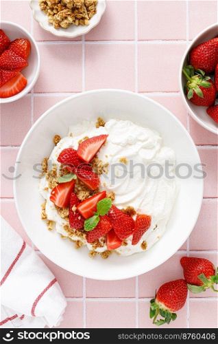 Yogurt with strawberry. Plain white greek yogurt with fresh berries and granola. Healthy food, breakfast. Top view