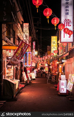 Yokohama, JAPAN - June 26, 2014 : Restaurant street - small alley with Chinese lanterns in China town Yokohama at night. Famous for delicious chinese food and shopping spot for tourist.