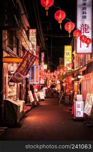 Yokohama, JAPAN - June 26, 2014 : Restaurant street - small alley with Chinese lanterns in China town Yokohama at night. Famous for delicious chinese food and shopping spot for tourist.