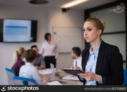 yonug blonde businesswoman in working on tablet computer at modern startup business office interior