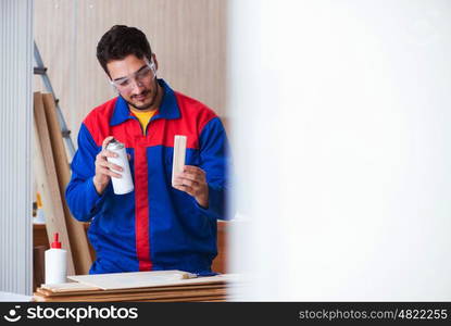 Yooung repairman carpenter working with paint painting