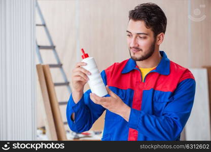 Yooung repairman carpenter working with paint painting