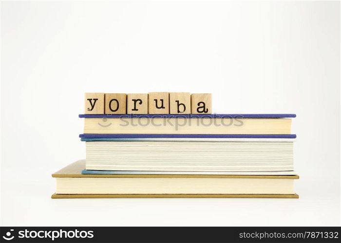 yoruba word on wood stamps stack on books, academic and language concept