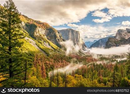 Yosemite National Park Valley at cloudy autumn morning from Tunnel View. Low clouds lay in the valley. California, USA.