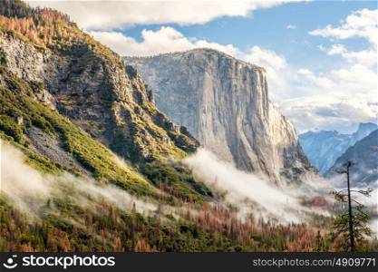 Yosemite National Park Valley at cloudy autumn morning from Tunnel View. Low clouds lay in the valley. California, USA.