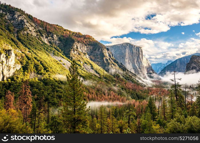 Yosemite National Park Valley at cloudy autumn morning from Tunnel View. Low clouds lay in the valley. California, USA.