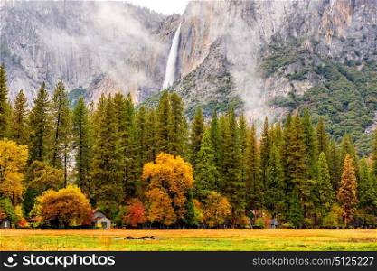 Yosemite National Park Valley with Yosemite Falls at cloudy autumn morning. Low clouds lay in the valley. California, USA.