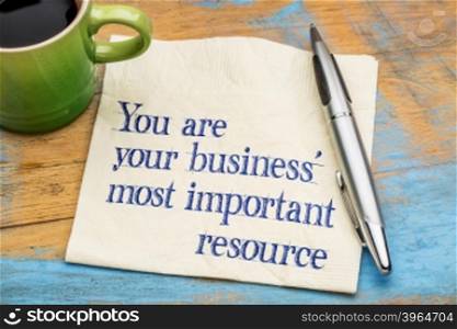 You are your business most important resource - reminder handwriting on a napkin with a cup of coffee