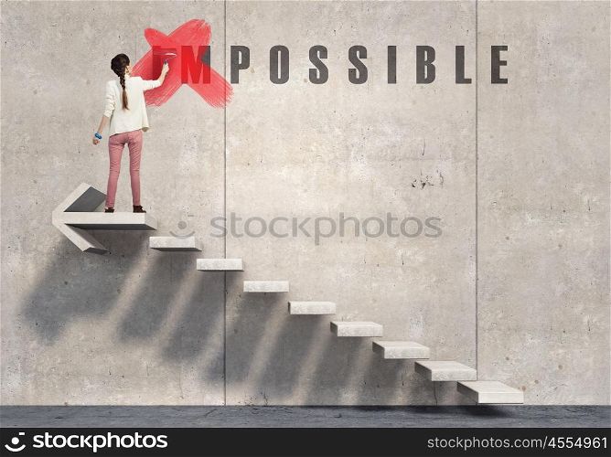 You can make it possible. Young woman crossing letters of word impossible