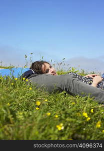 You couple lying in the grass.