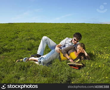 You couple lying in the grass.