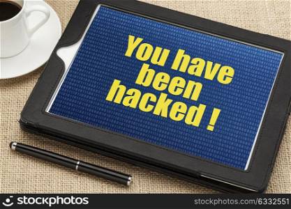 you have been hacked - text with a binary background on a digital tablet
