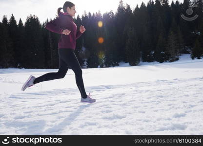 yougn woman jogging outdoor on snow in forest, healthy winter lifestyle and recreation