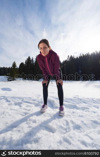 yougn woman jogging outdoor on snow in forest, healthy winter lifestyle and recreation