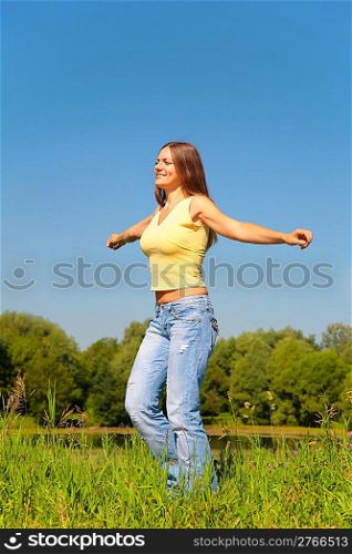 Youmg woman dancing in park