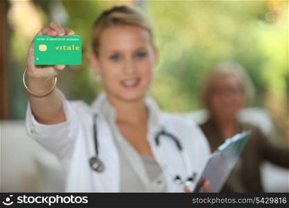 youn doctor showing card