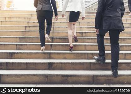 Young active business people walking up stair to go to work in modern city. Crowded group of people in big city lifestyle with briefcase, smart phone, cup of coffee. Business Lifestyle Concept.