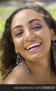 Young-adult African American woman laughing and making eye contact.