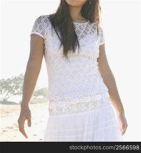 Young adult Asian female at beach with soft lighting.
