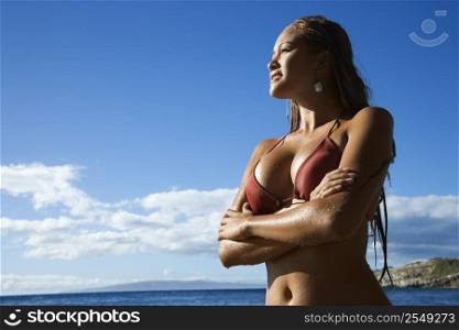 Young adult Asian Filipino in bikini on beach in Maui Hawaii.
