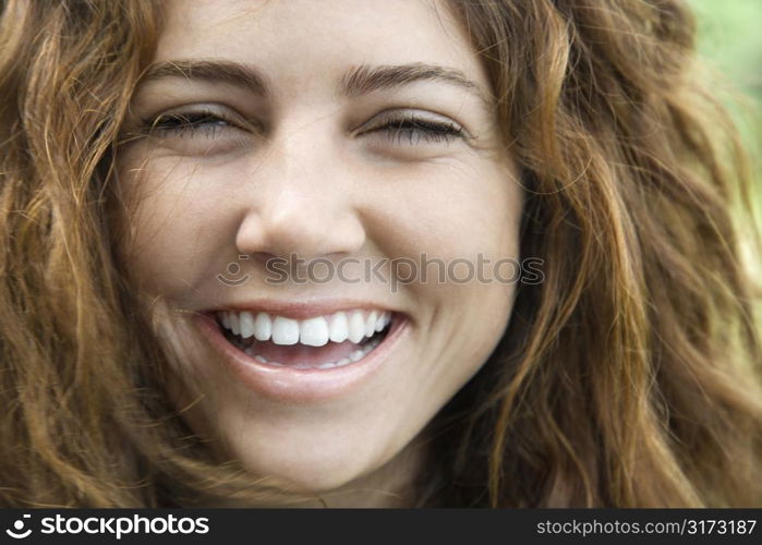 Young adult Caucasian female smiling and looking at viewer.