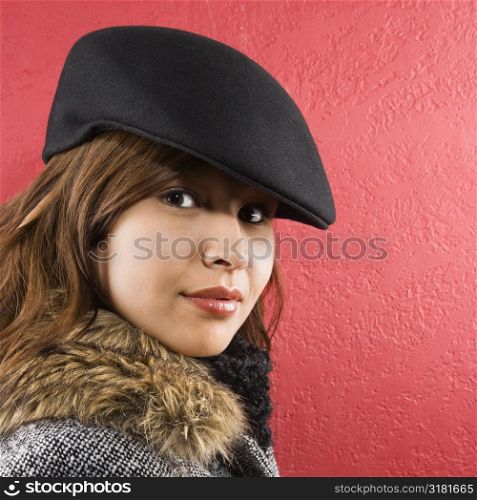 Young adult Caucasian woman wearing flat hat looking at viewer.