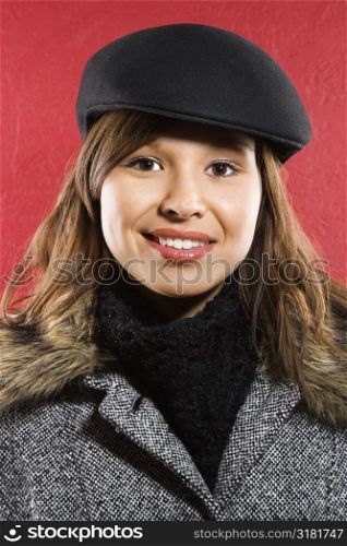 Young adult Caucasian woman wearing flat hat smiling at viewer.