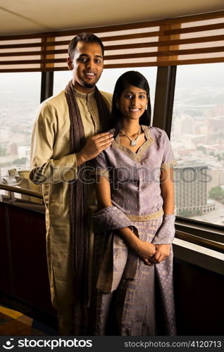 Young Adult Couple By High Rise Windows