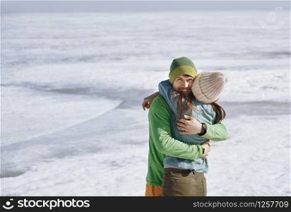 Young adult couple having fun in winter landscape