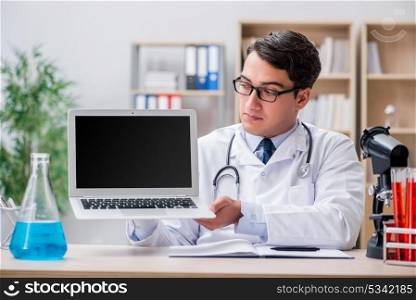 Young adult doctor with laptop computer