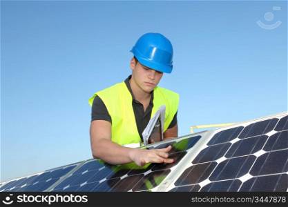 Young adult doing professional training on solar panels plant