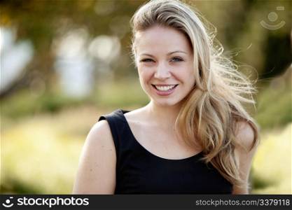 Young adult female model in outdoor setting. Horizontally framed shot.