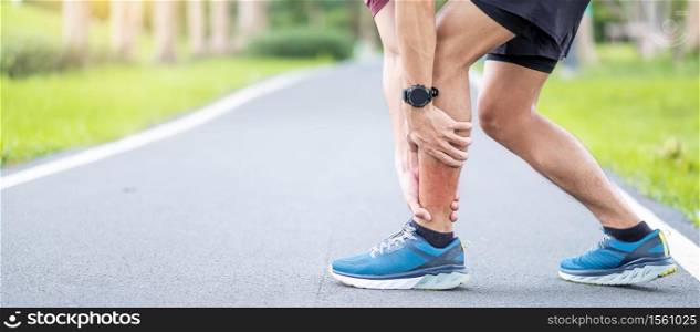 Young adult male with his muscle pain during running. runner man having leg ache due to Calf muscle pull. Sports injuries and medical concept