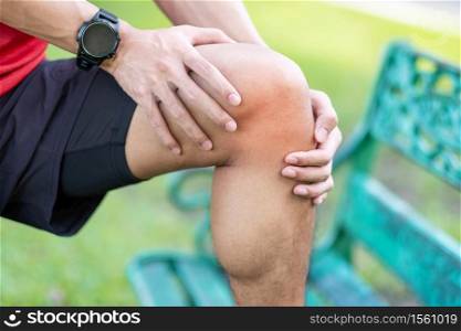Young adult male with muscle pain during running. runner have knee ache due to Runners Knee or Patellofemoral Pain Syndrome, osteoarthritis and Patellar Tendinitis. Sports injuries and medical concept