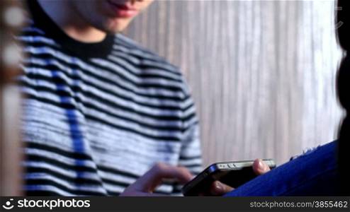 young adult man using and play touchscreen phone.