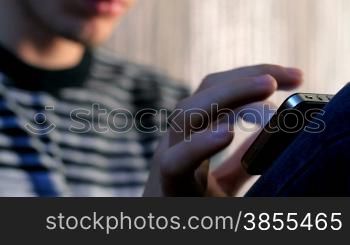 young adult man using and play touchscreen phone.