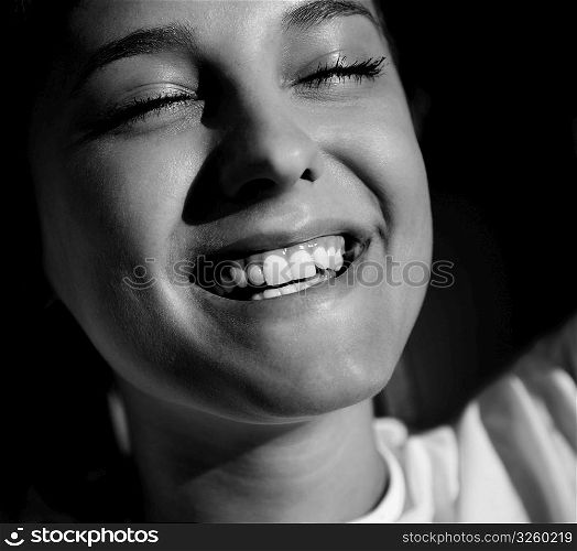 young adult smiling, natural sunlight, selective focus on eye