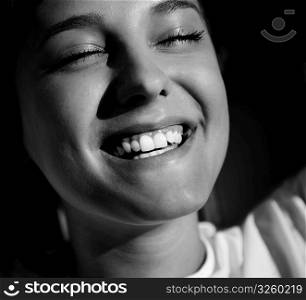young adult smiling, natural sunlight, selective focus on eye