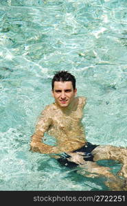 young adult smiling on translucid water in a Maldivian Island