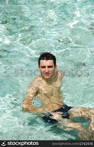 young adult smiling on translucid water in a Maldivian Island