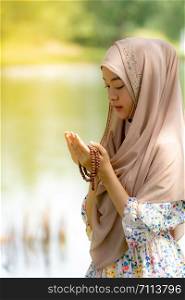 Young Adult teenager Woman making Duas for Muslim god blessing prayer.