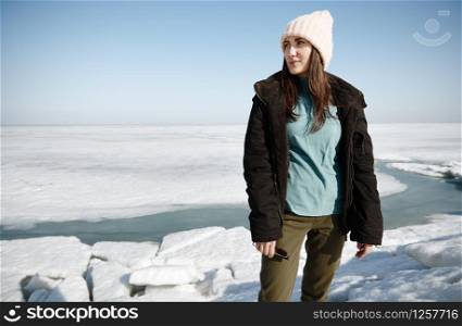 Young adult woman outdoors enjoying icy landscape