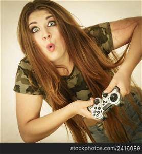 Young adult woman playing on the video console holding game pad. Gaming gamers concept.. Gamer woman holding gaming pad